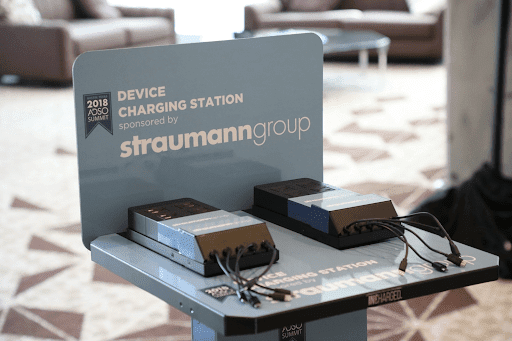 Live action photo of phone charging station with custom graphics at trade show