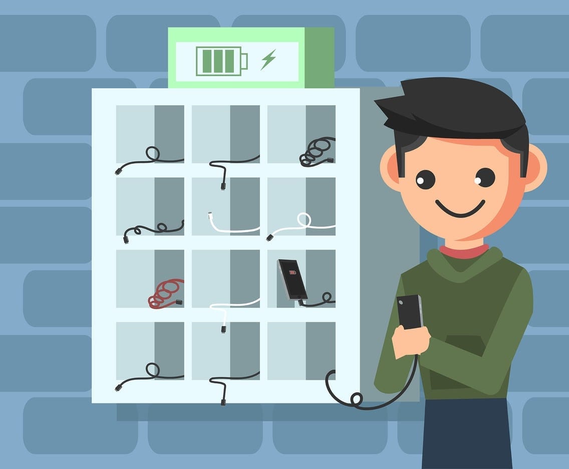 Cartoon man charging phone in cubby mounted on brick wall