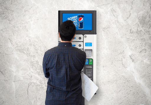 Man using phone locker charging station with digital signage