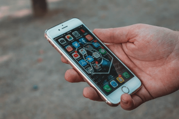 Closeup of man holding white iPhone outside
