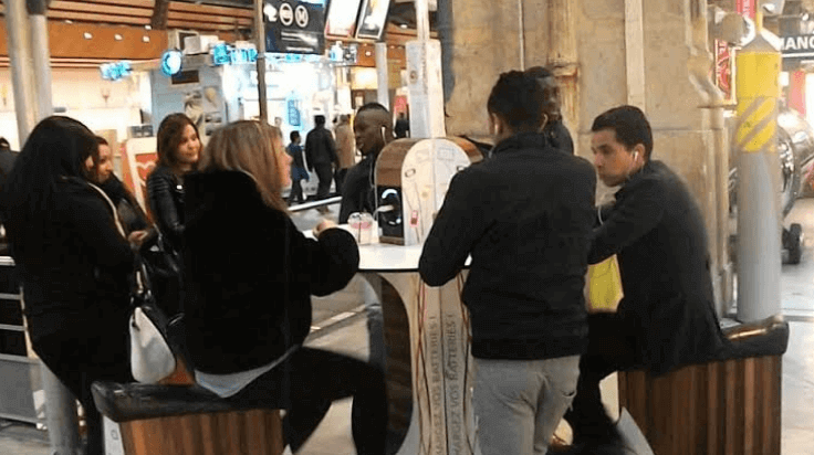 People using public phone charging station hub