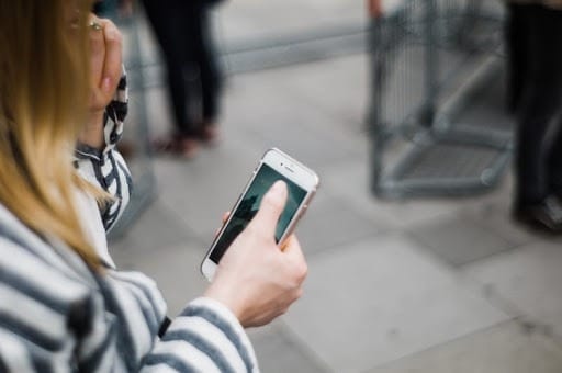 Business casual woman overhead view using smart phone outside
