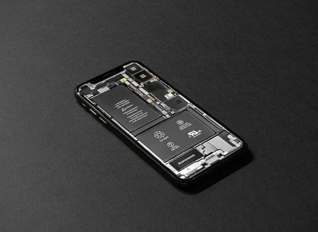 Black android smartphone on table phone charging station